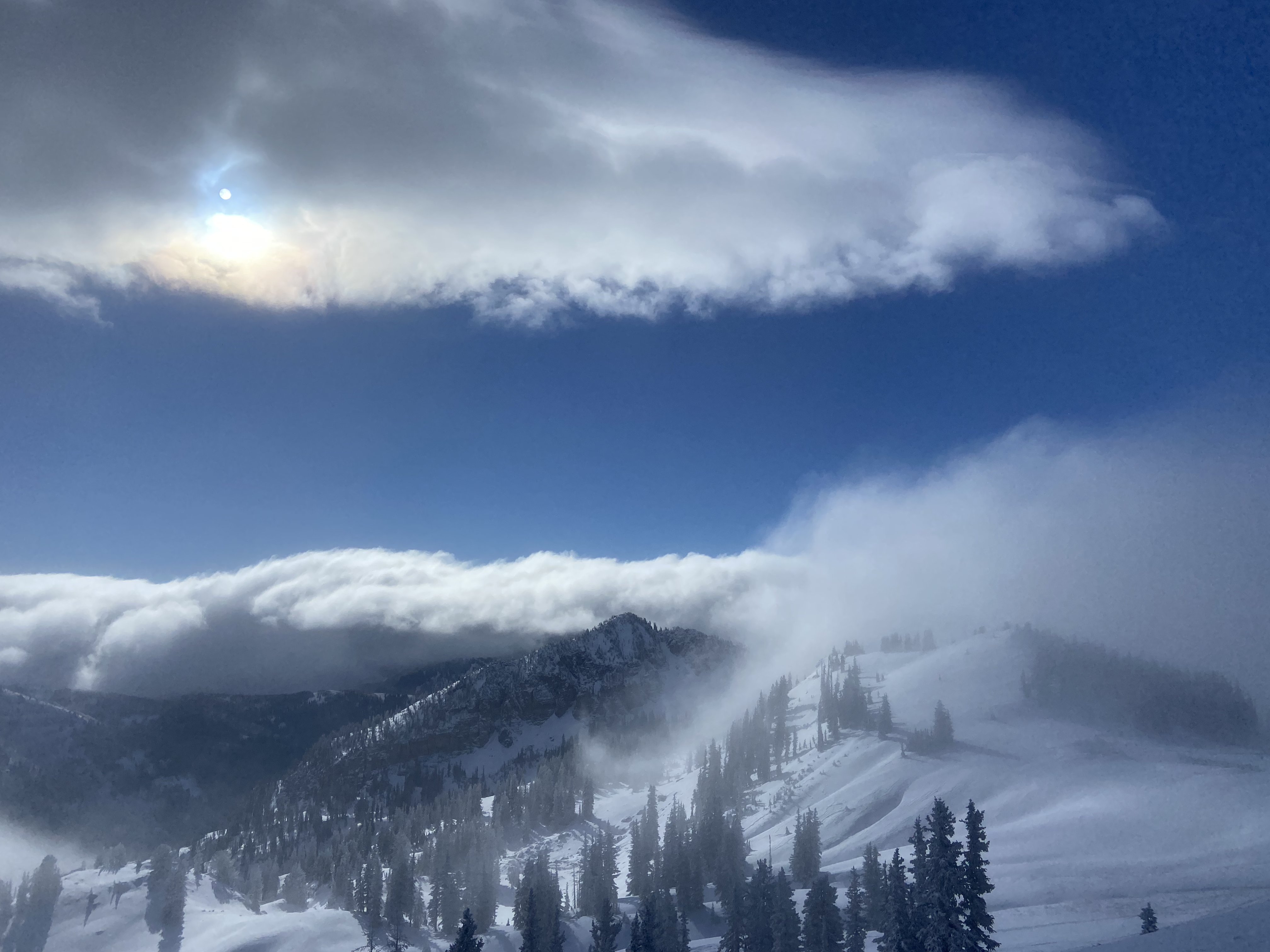 Storm clouds over a snow-covered mountain ridge